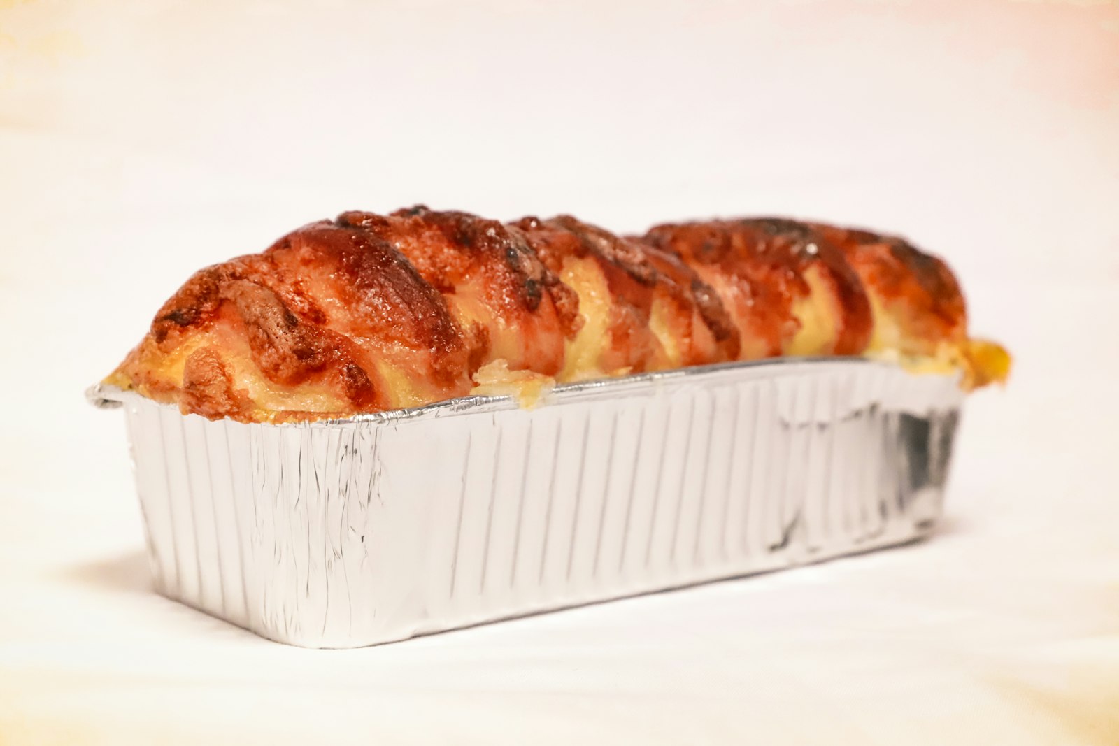 Bacon wrapped loaf in a baking pan