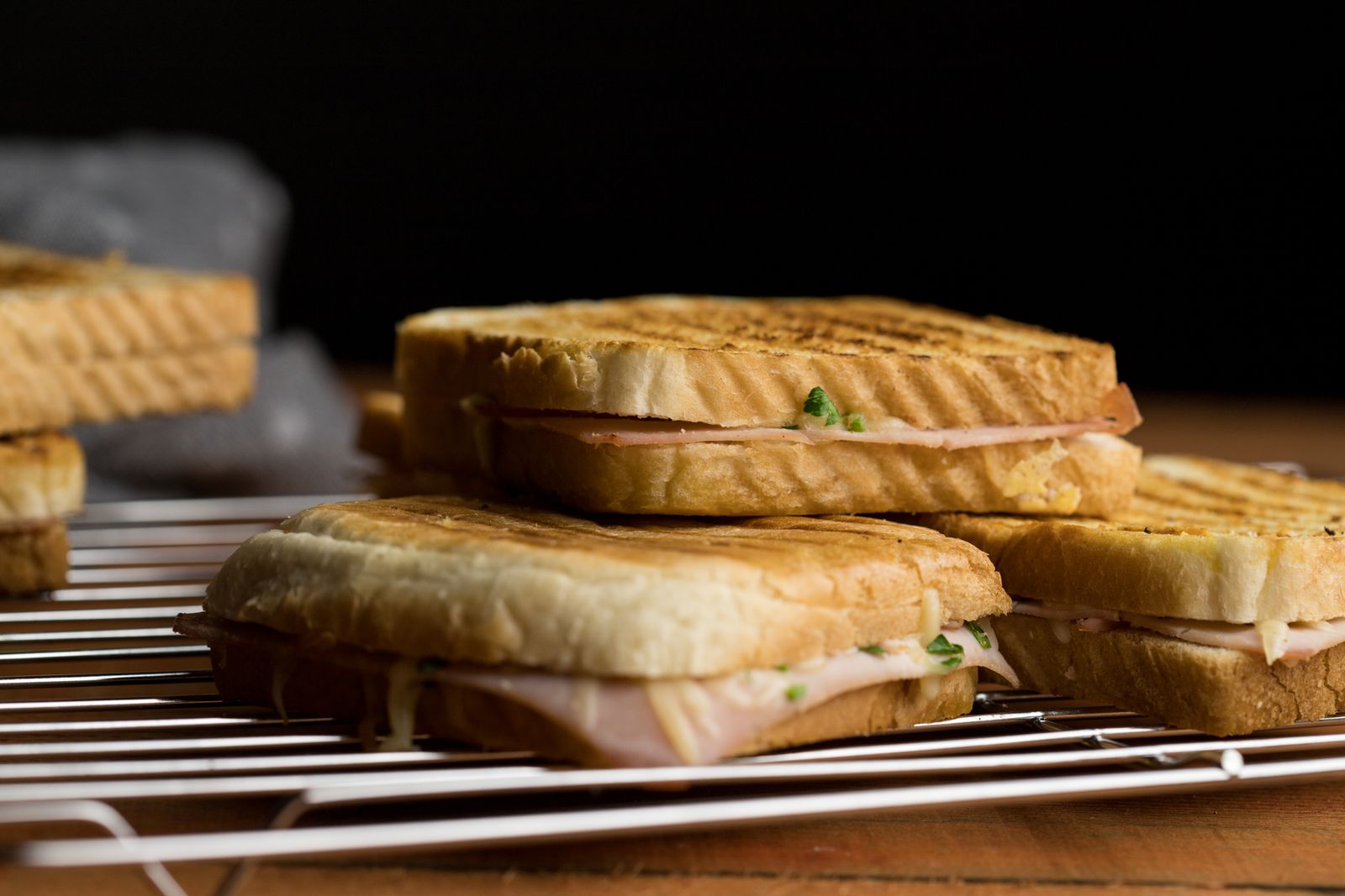 Batch of toasted sandwiches on a cooling rack