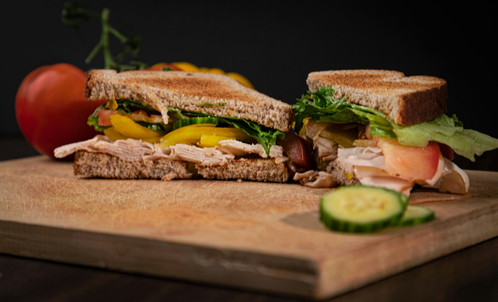 Turkey sandwich cut in half on a cutting board