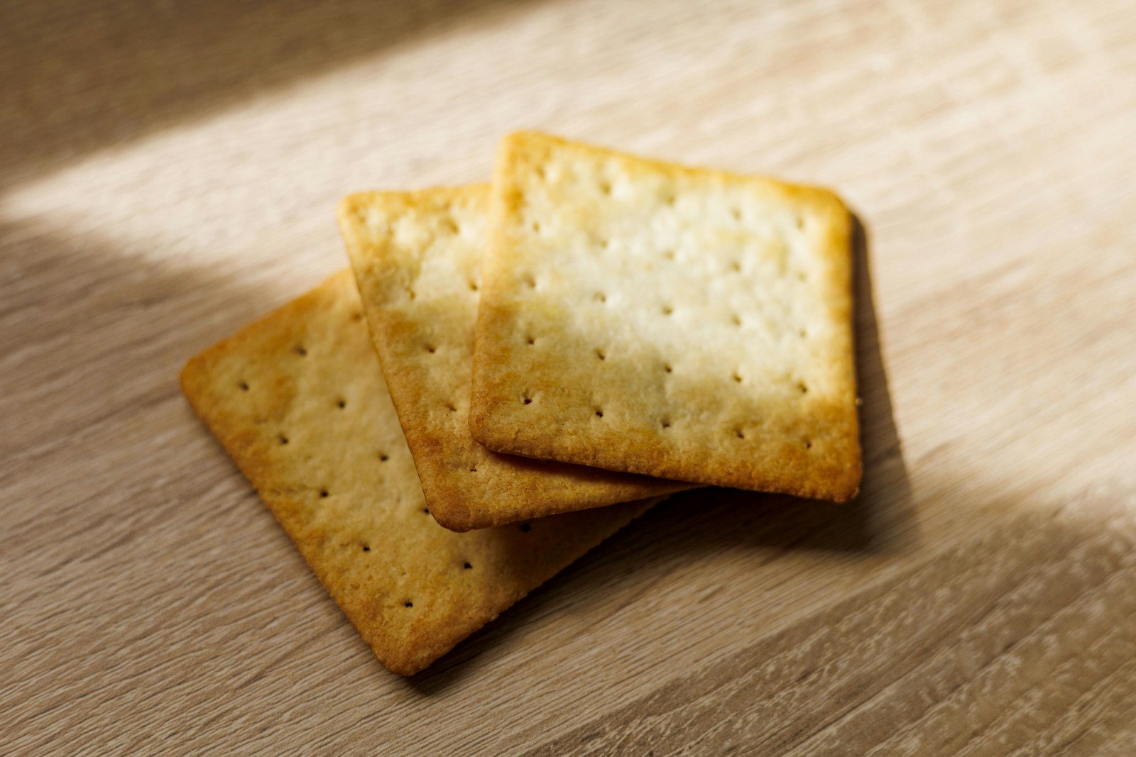 Square crackers on a wooden table