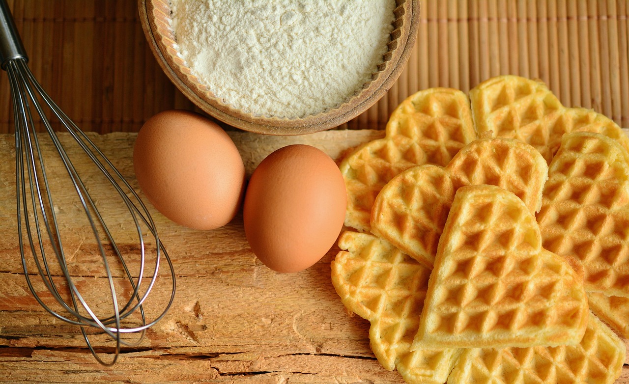 Flour, eggs and a whisk ready for baking