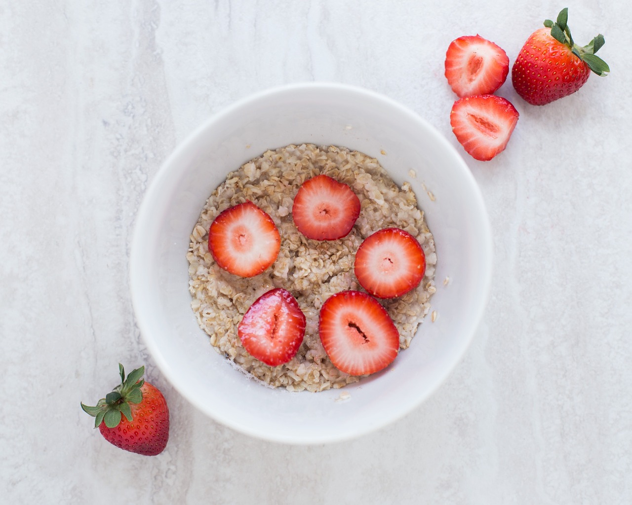 Bowl of oats with strawberries for an Arnold Schwarzenegger style breakfast