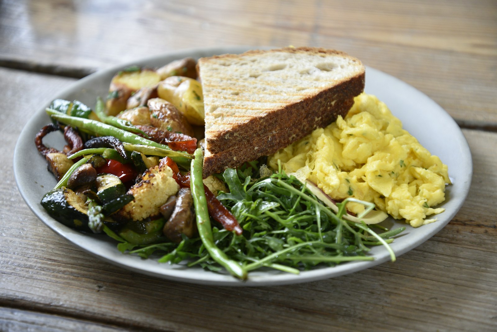 Veggie scramble plate with greens and toast