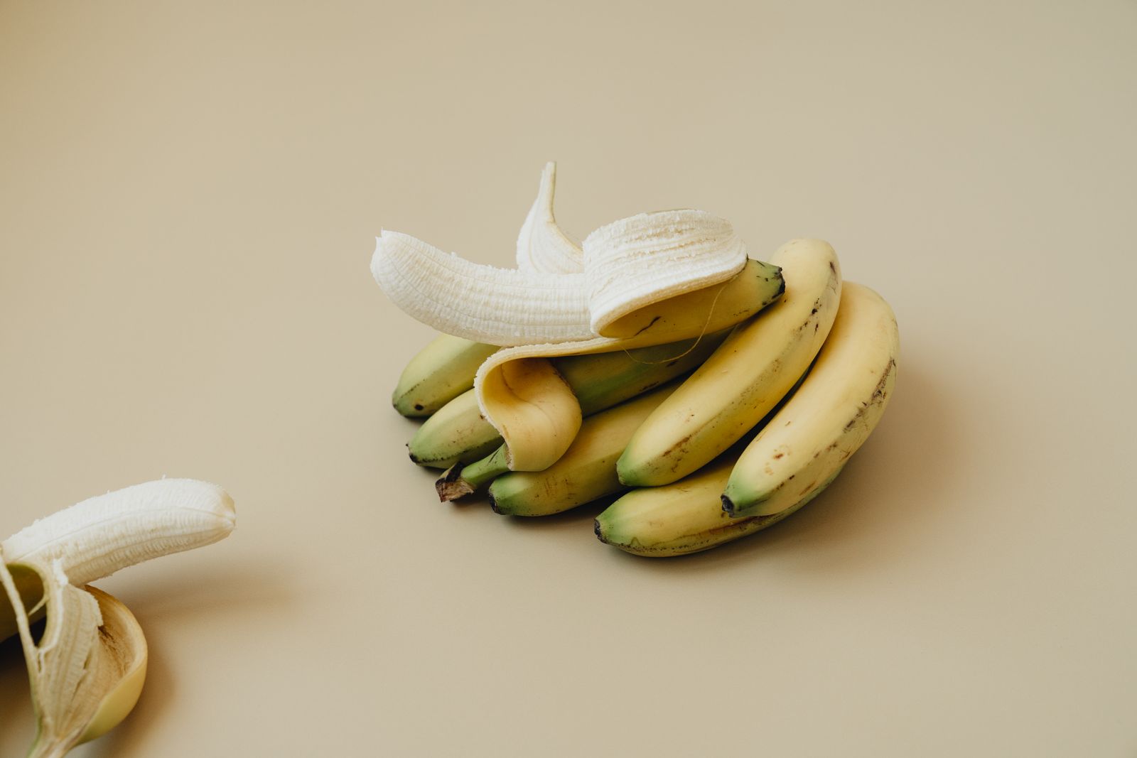 Peeled bananas on a beige table