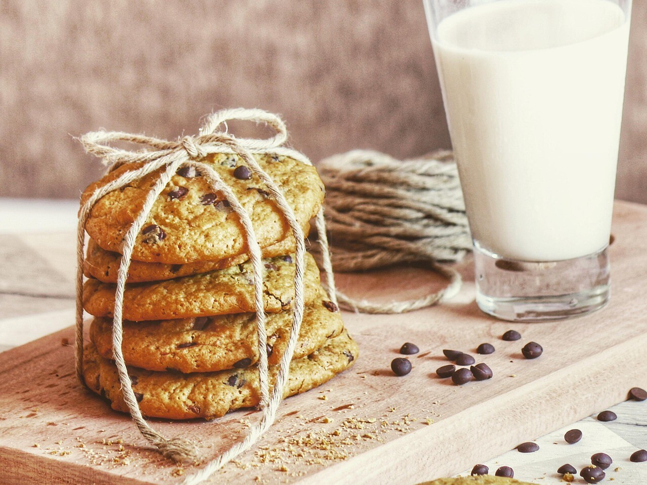 Stack of cookies next to a glass of milk