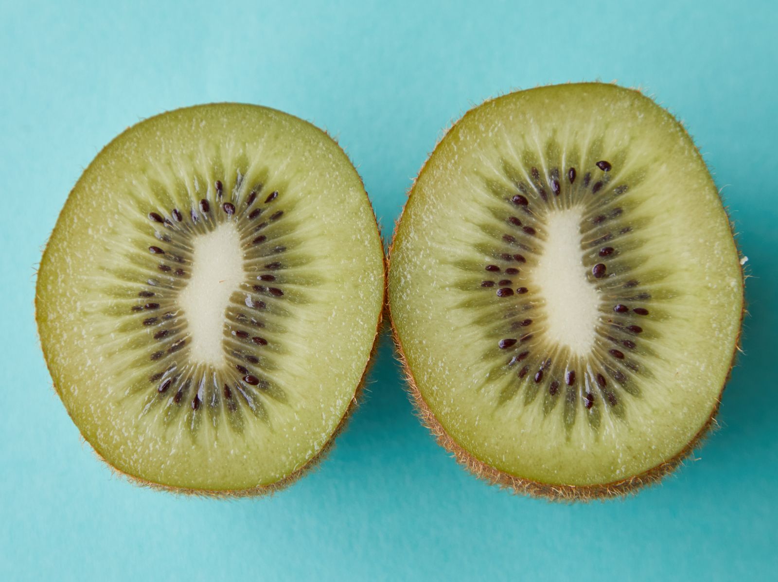 Kiwi halves ready for eating with a spoon