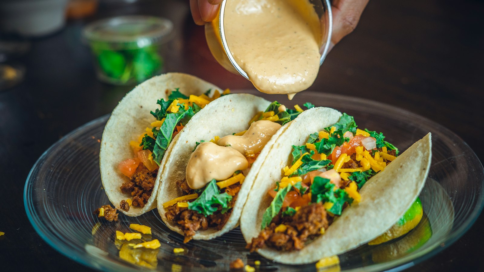 Tacos with salsa poured on top, ready for eating