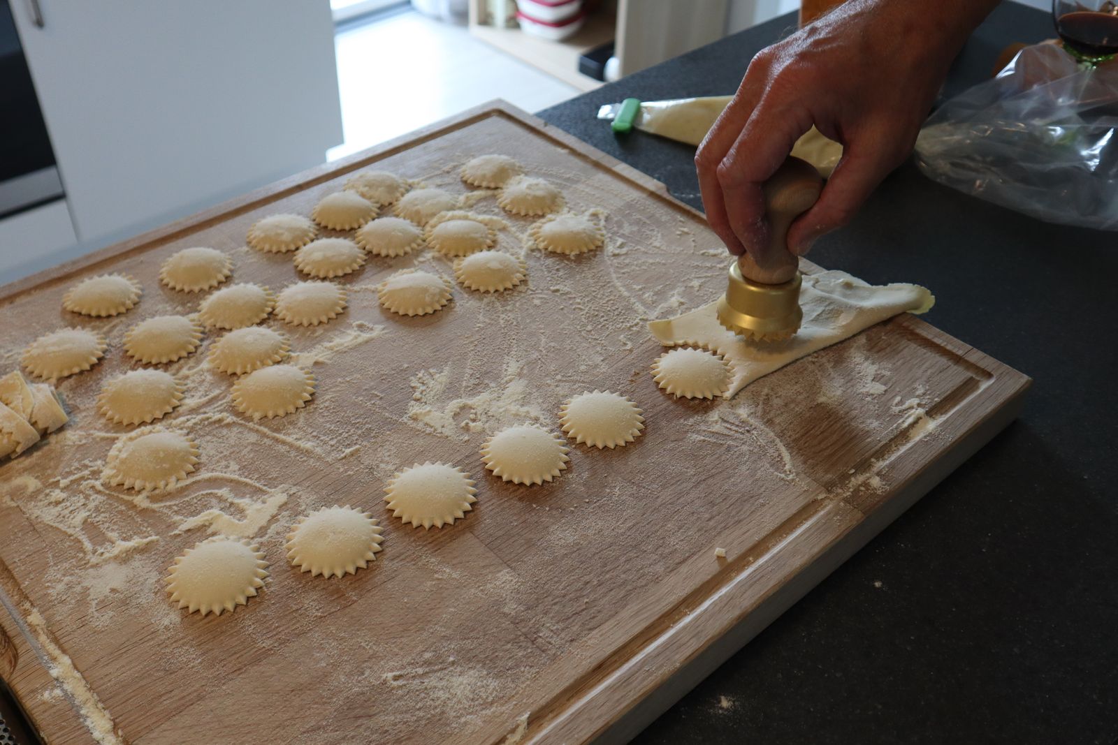 Cutting homemade ravioli on a floured board