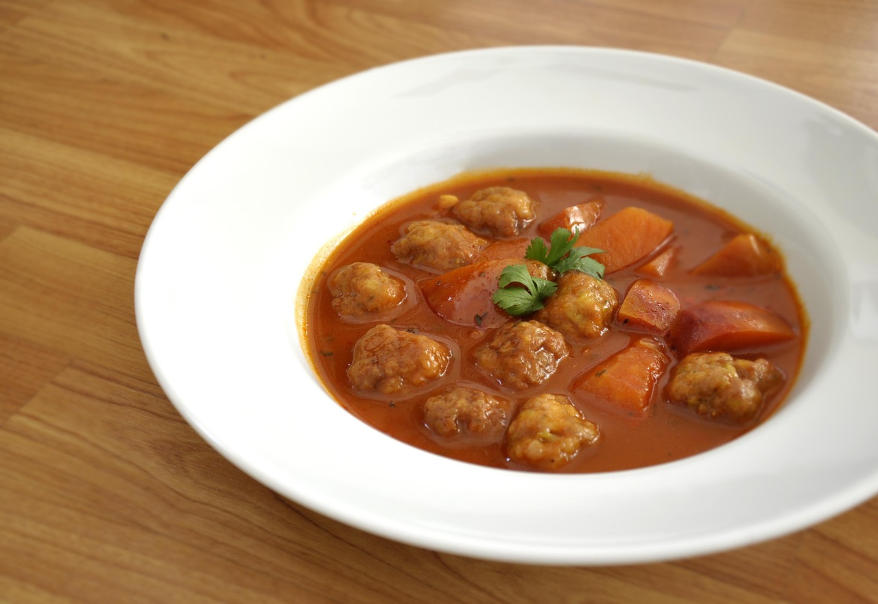 Little meatballs simmered in a red broth