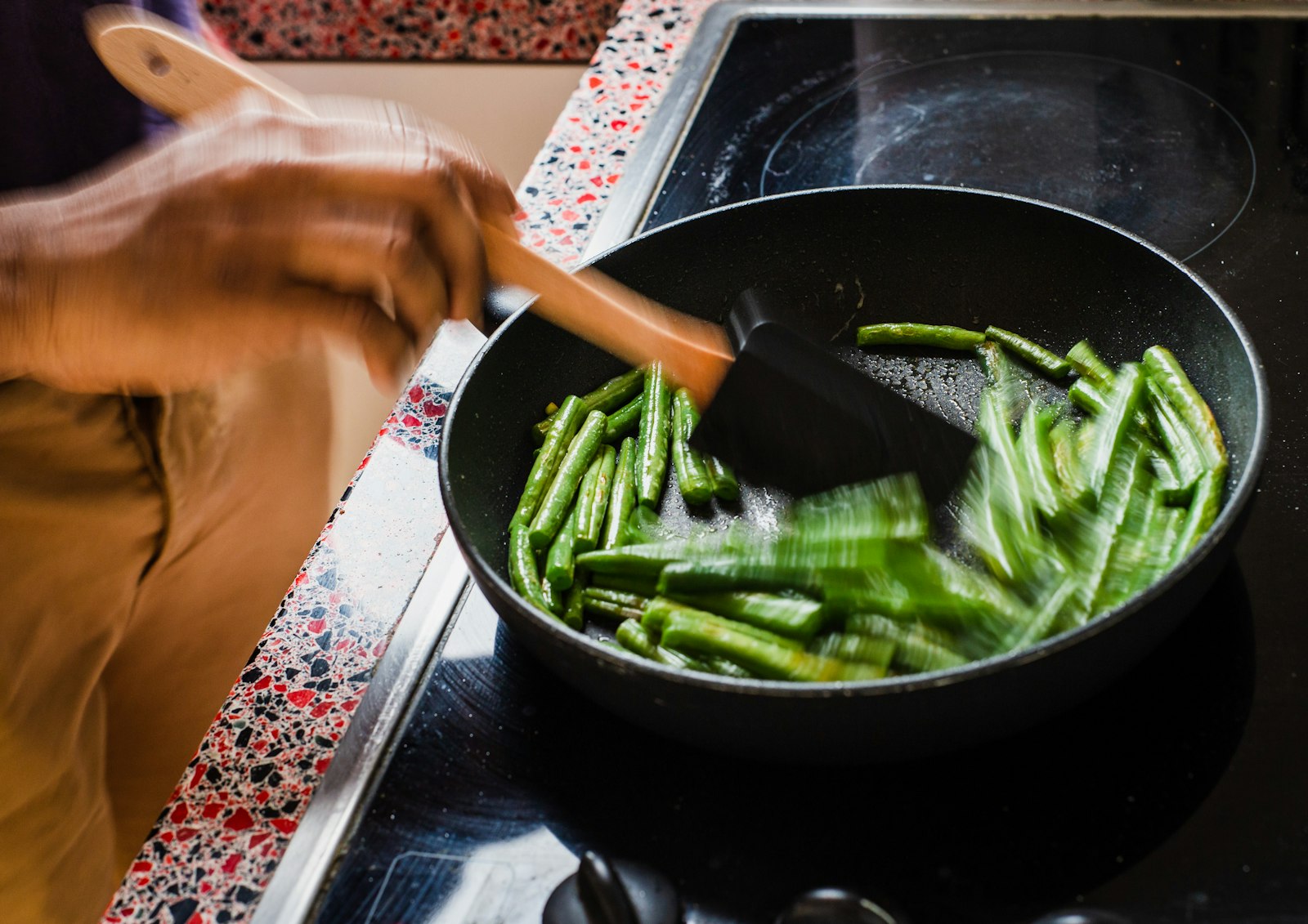 Green beans sizzling in a skillet