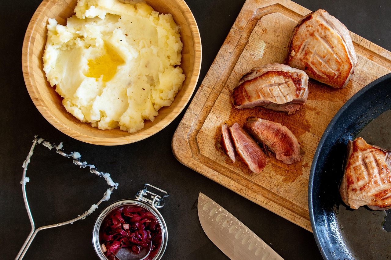 Creamy mash in a bowl beside a holiday plate