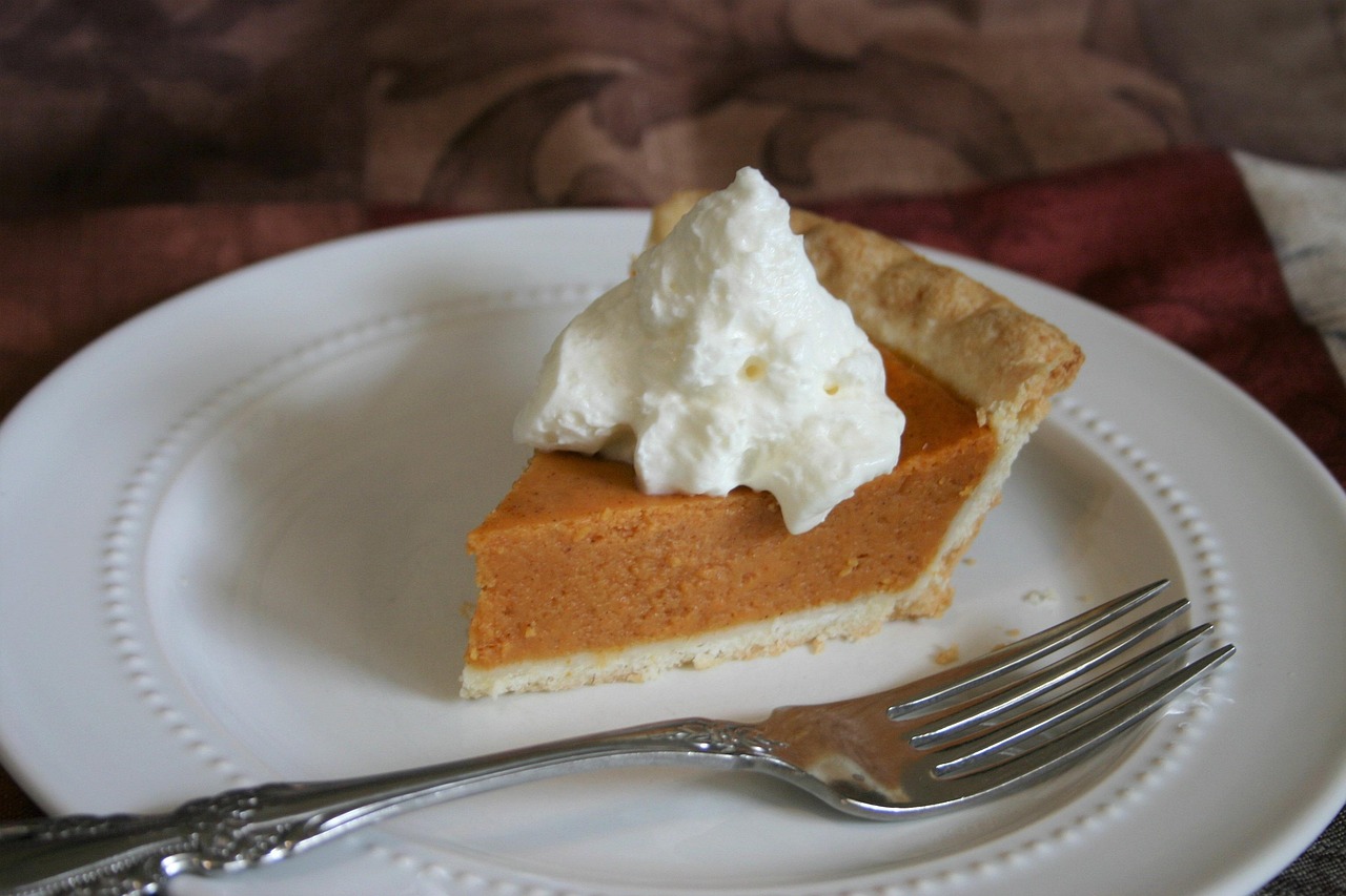 Slice of pumpkin pie with whipped cream for a lower sugar Thanksgiving