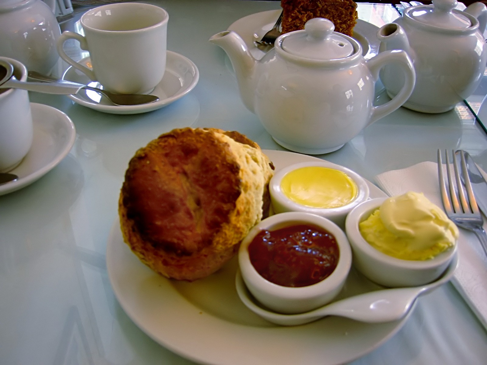 Scone with clotted cream and jam served with tea