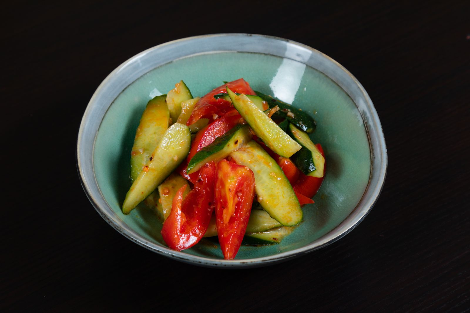 Cucumber salad with red chili in a bowl