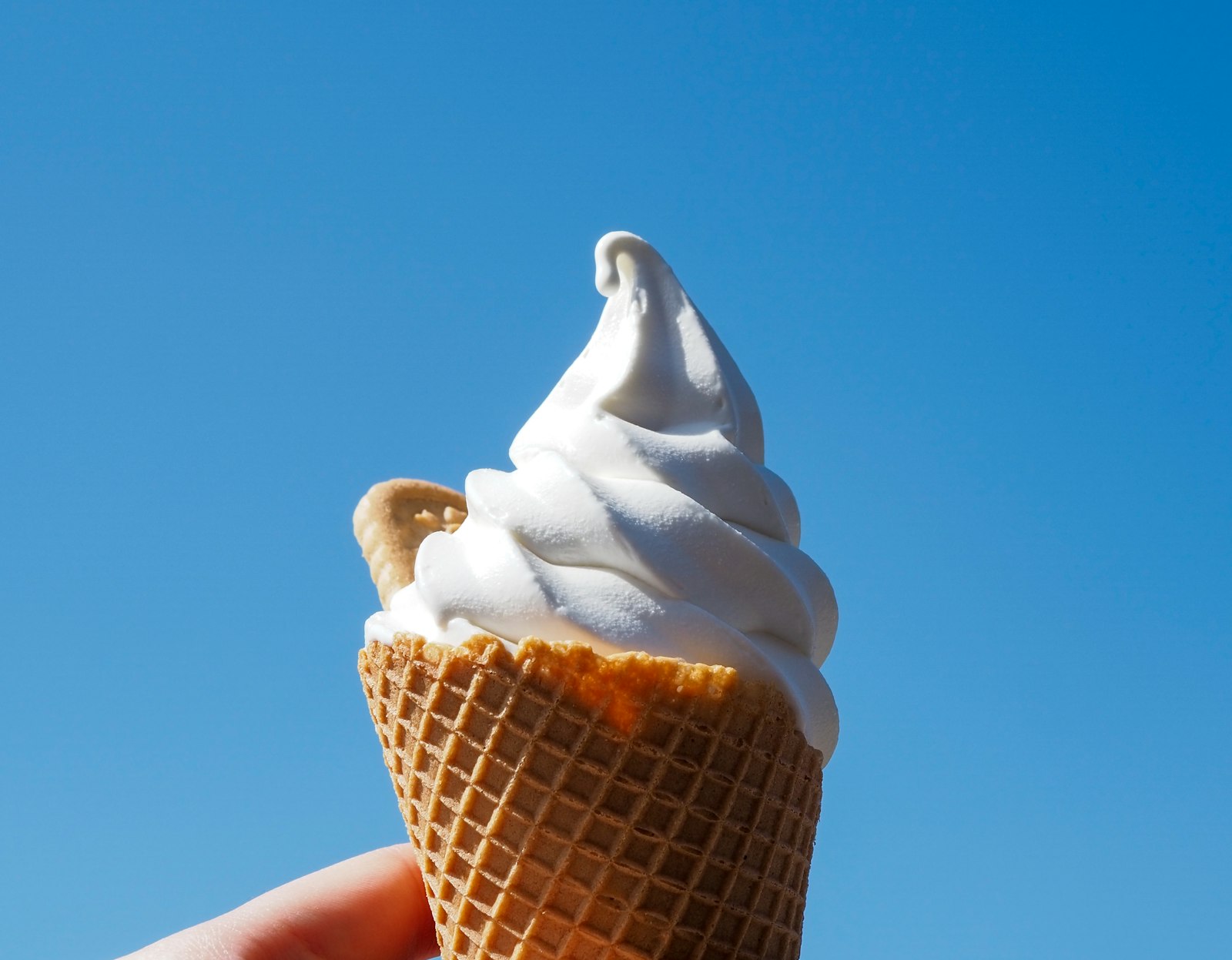 Vanilla soft serve ice cream in a cone