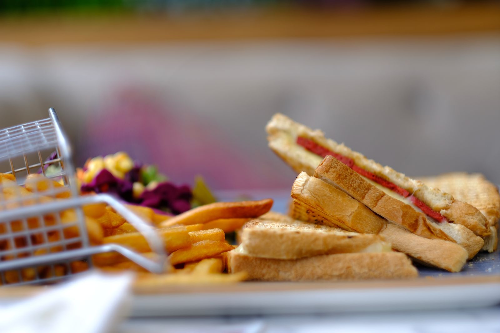 Toasted sandwiches with fries on a board