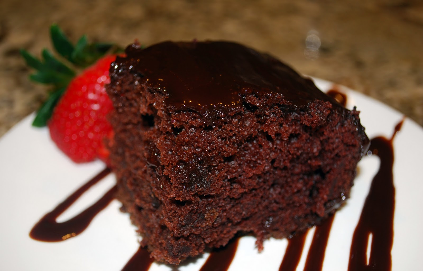 A slice of eggless Depression cake with chocolate sauce