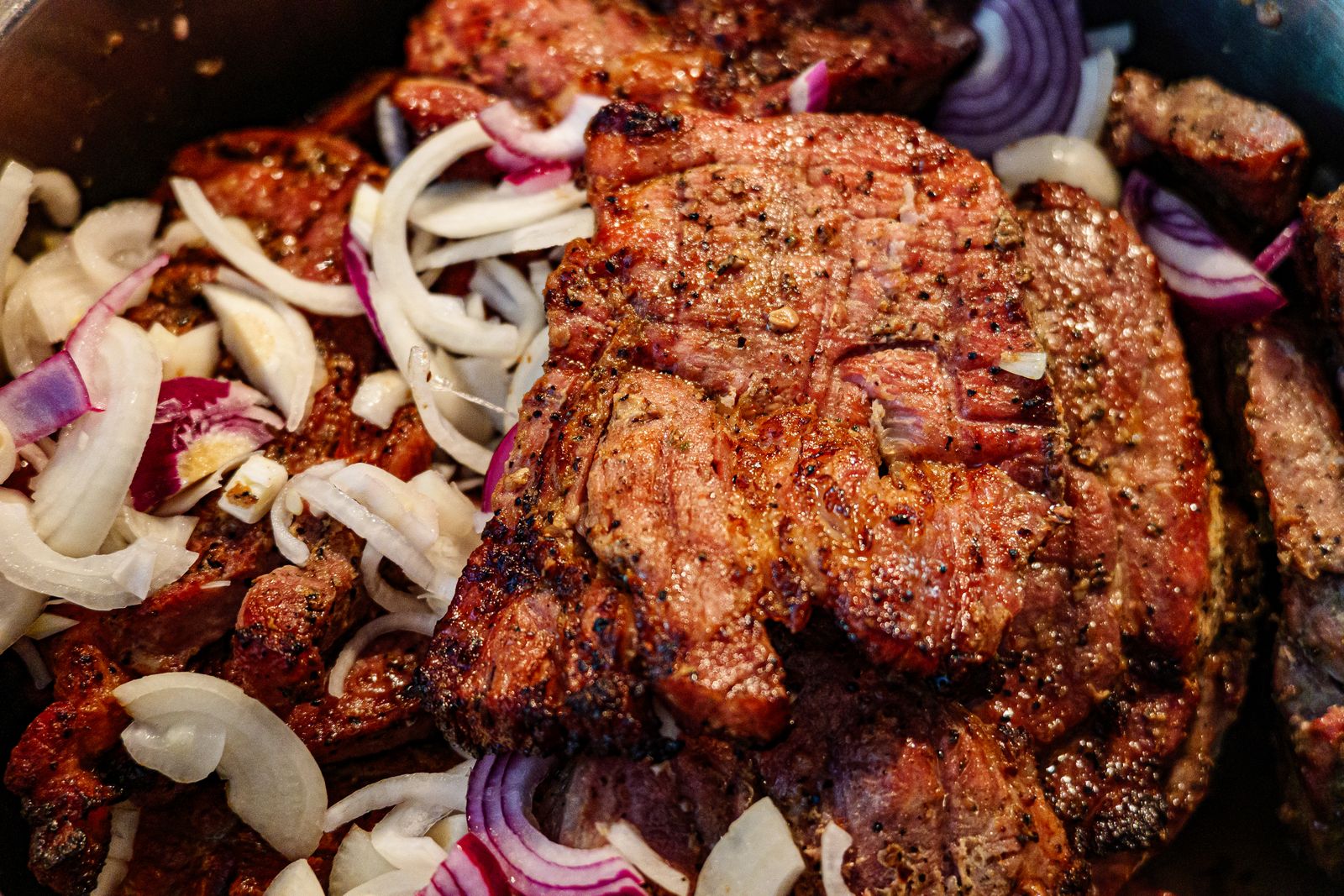 Pan fried meat topped with onions
