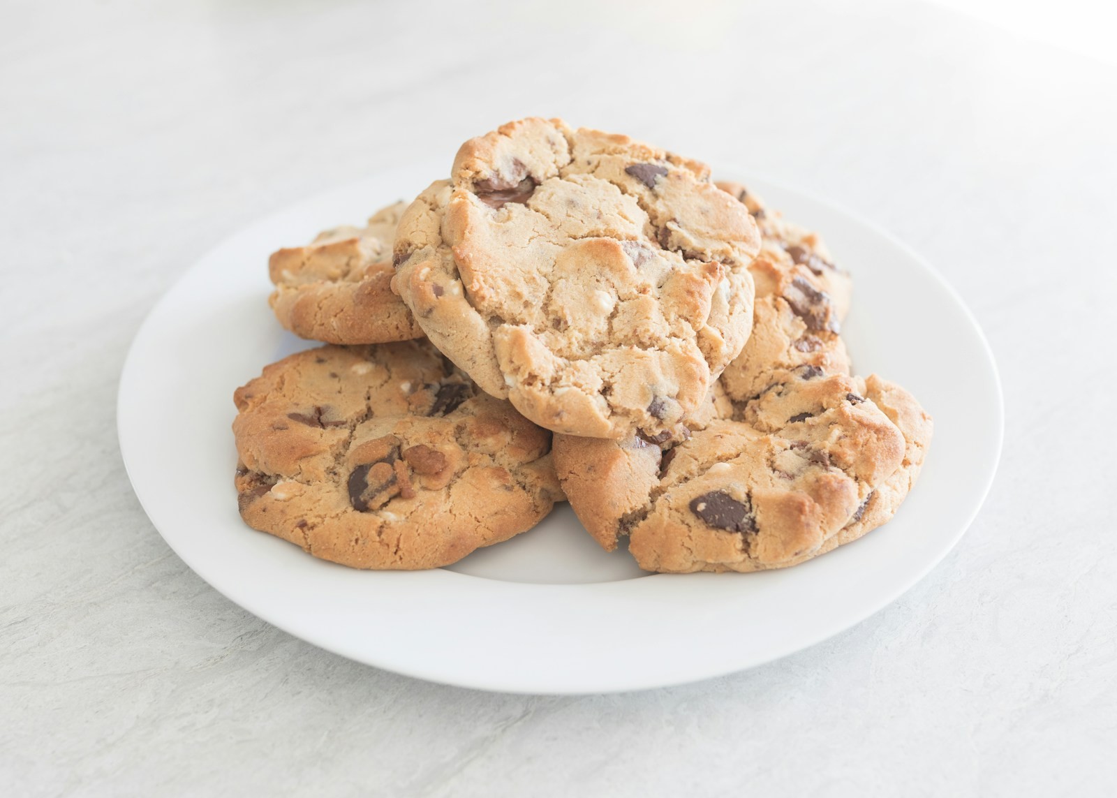 Brown butter chocolate chunk treats piled on a white plate