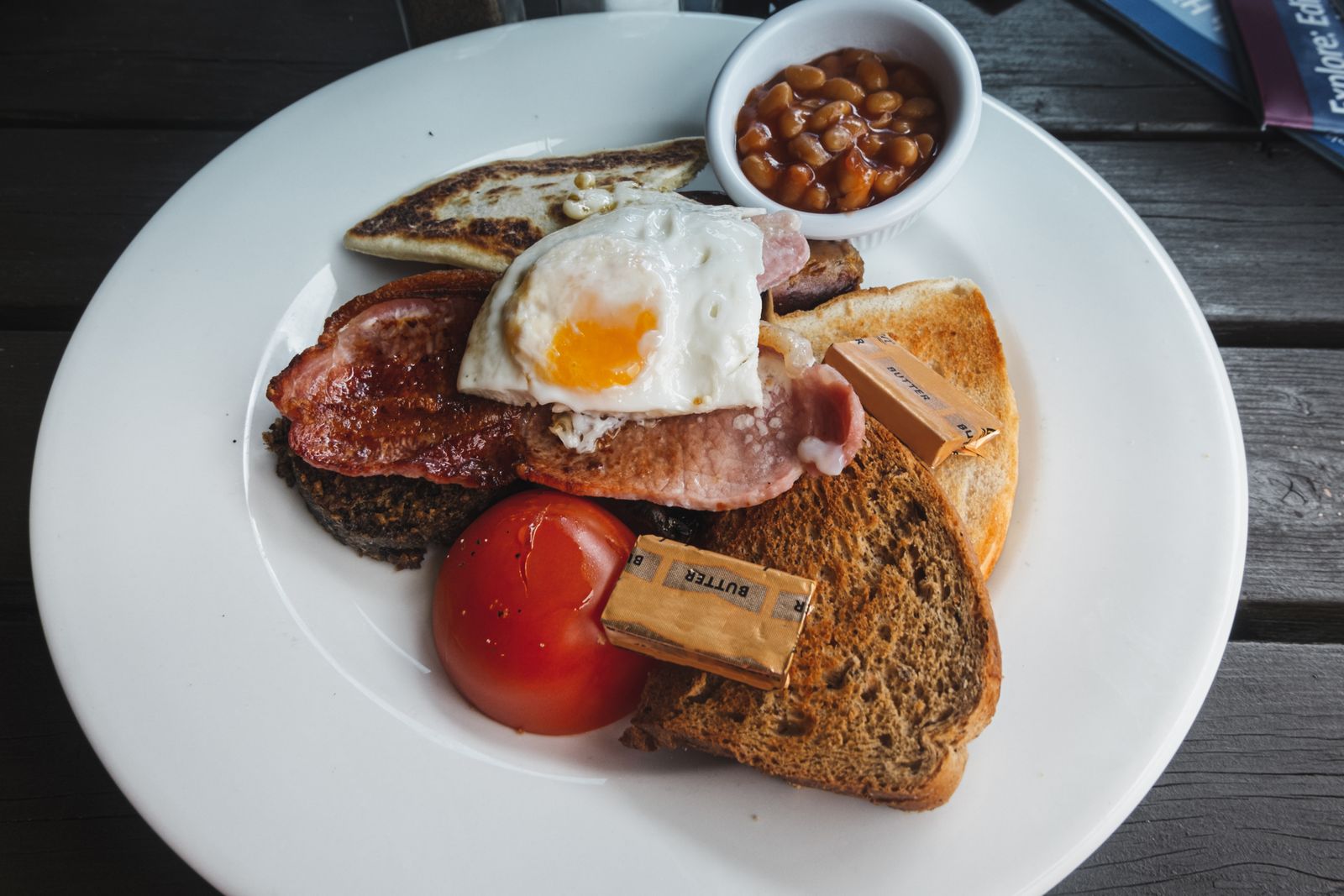 A full English breakfast with eggs, bacon, sausage, beans and toast