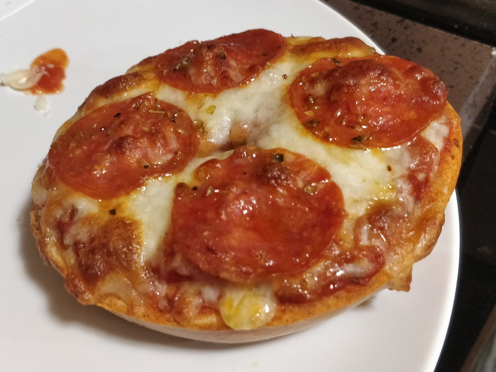 Pizza flavored dinners for kids: toasted bagel half topped with tomato sauce, melted cheese and large pepperoni slices
