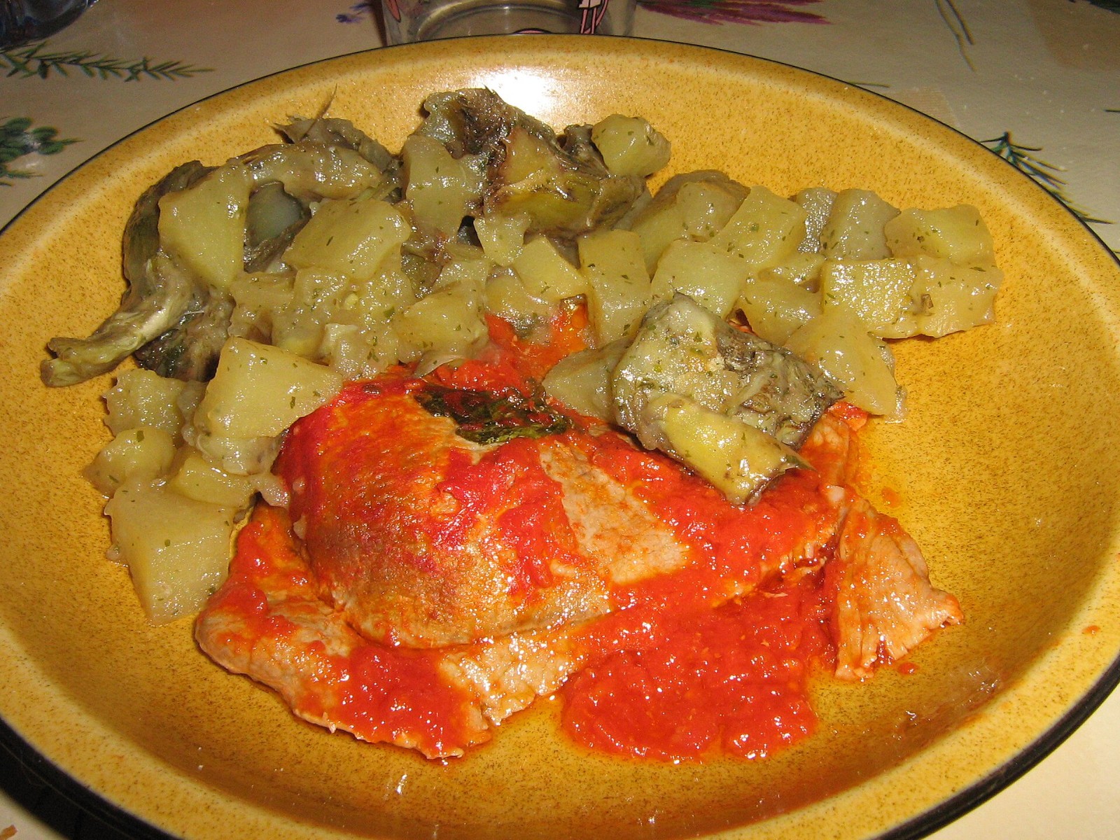 Italian steak in a rich tomato and oregano sauce with roasted potatoes and artichokes