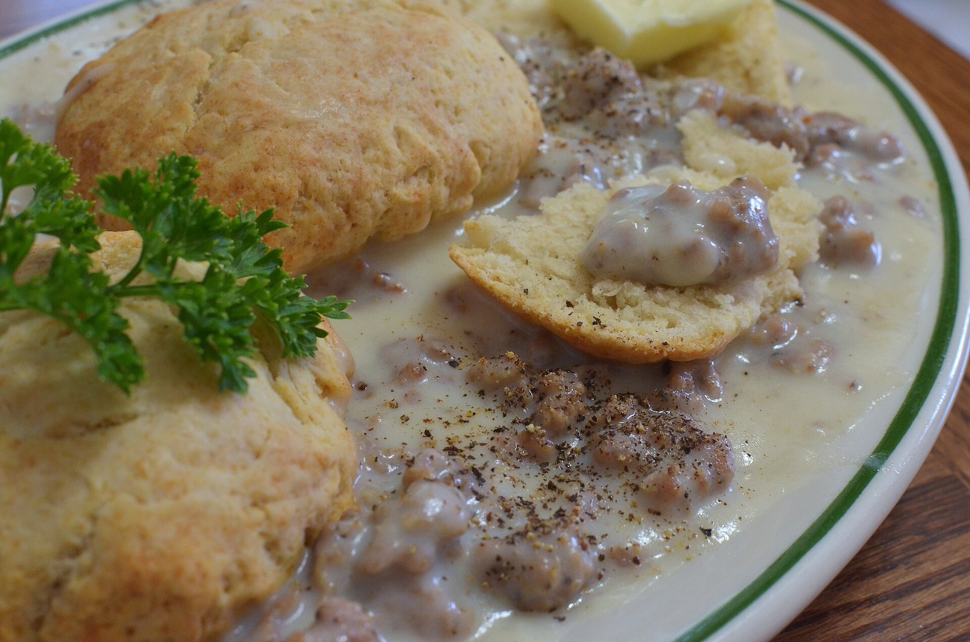 Fluffy biscuits smothered in peppery sausage gravy with parsley