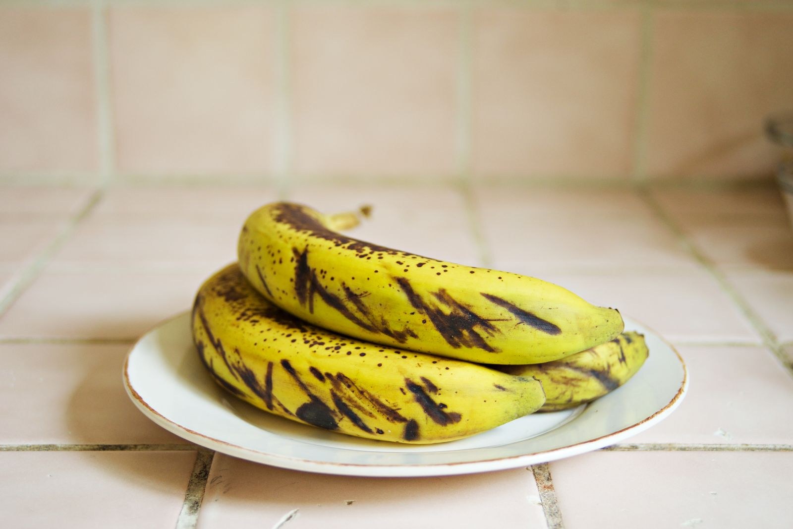 Freezer hacks: spotty ripe bananas on a plate, ready to peel and freeze for baking