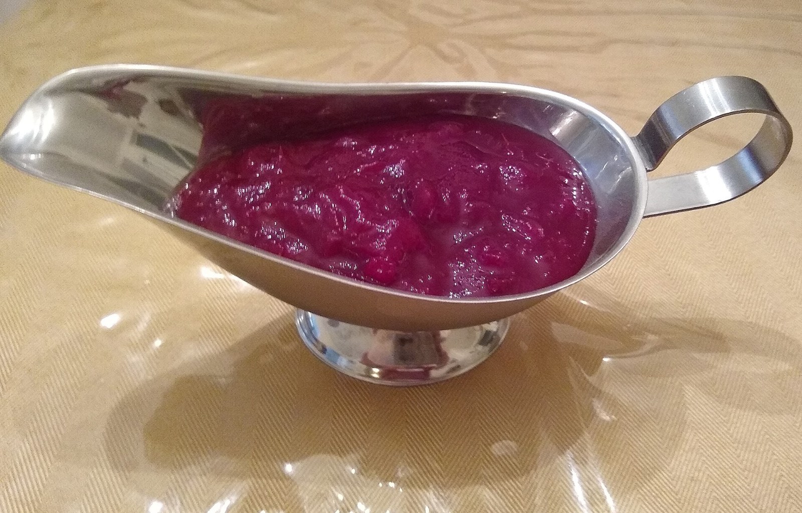 Thanksgiving foods: homemade cranberry sauce in a gravy boat