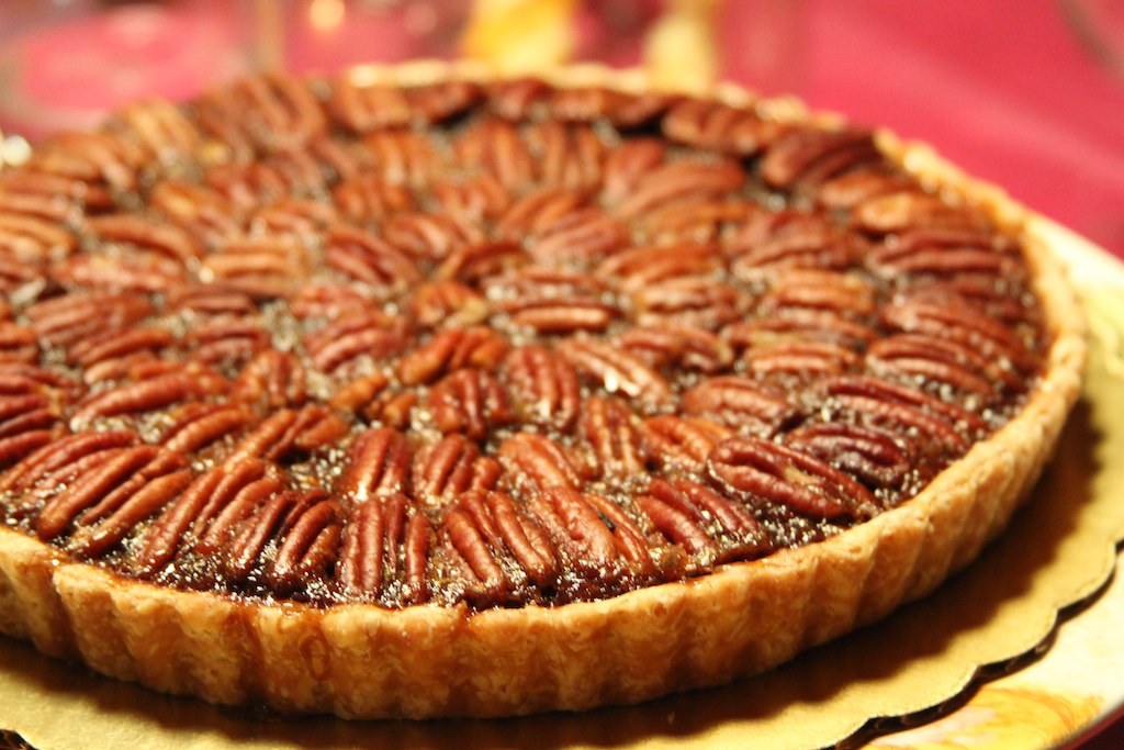 Thanksgiving foods: pecan pie topped with pecan halves