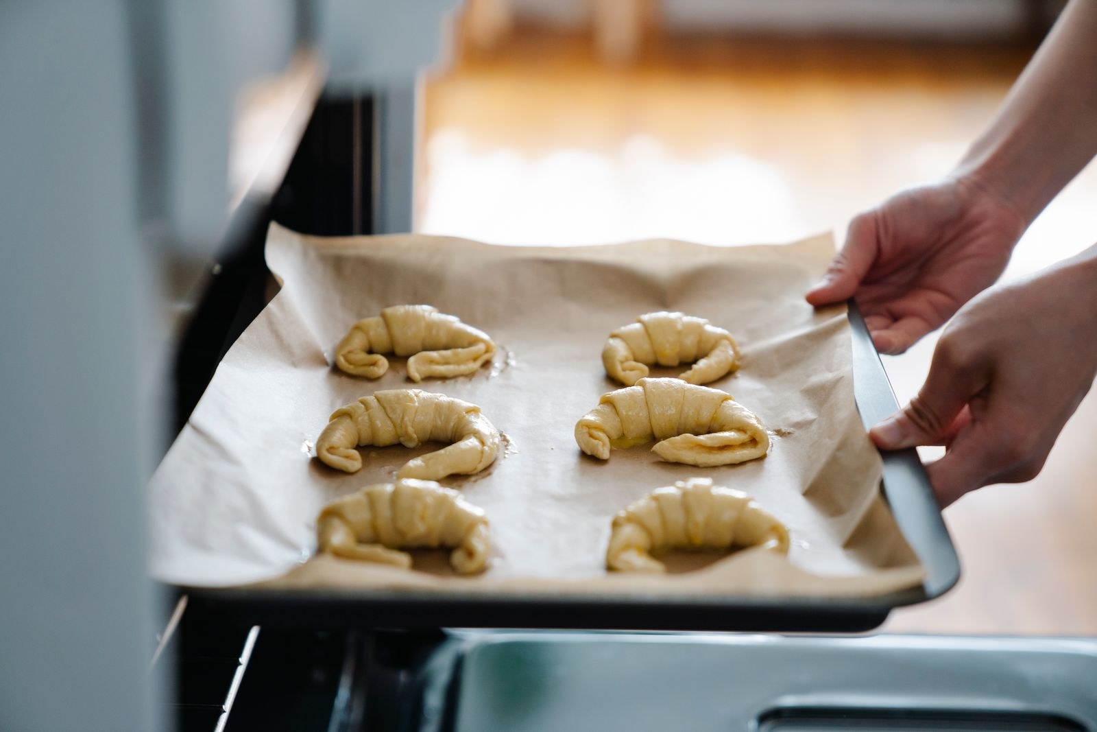 Kitchen prep hacks: a parchment lined baking sheet going into the oven