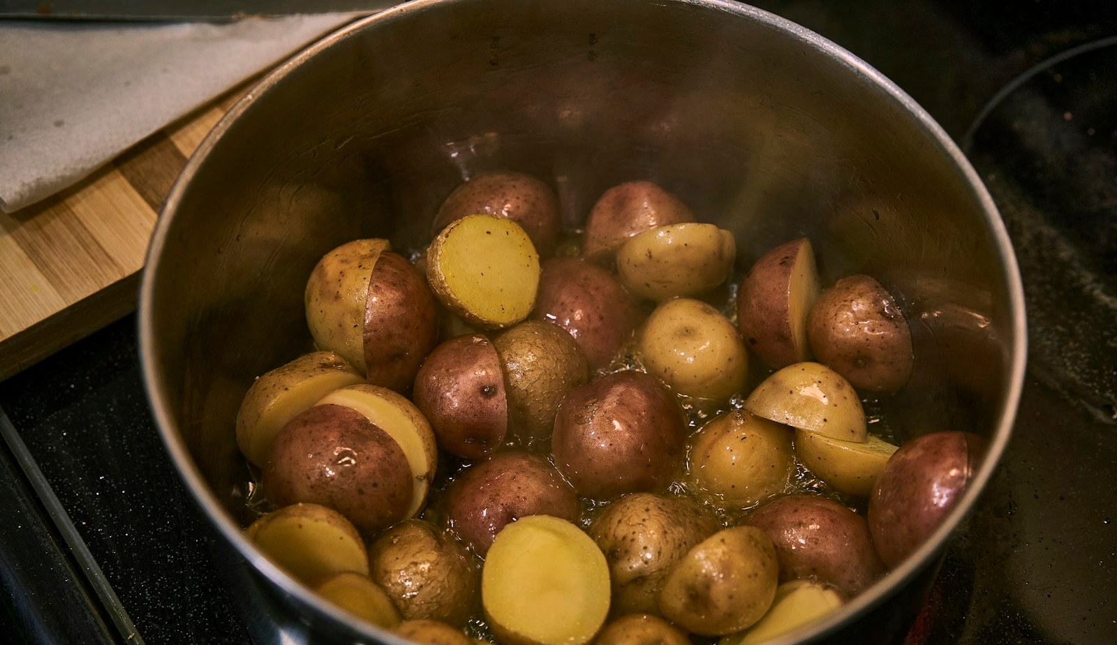 Potatoes boiling in a pot of starchy water