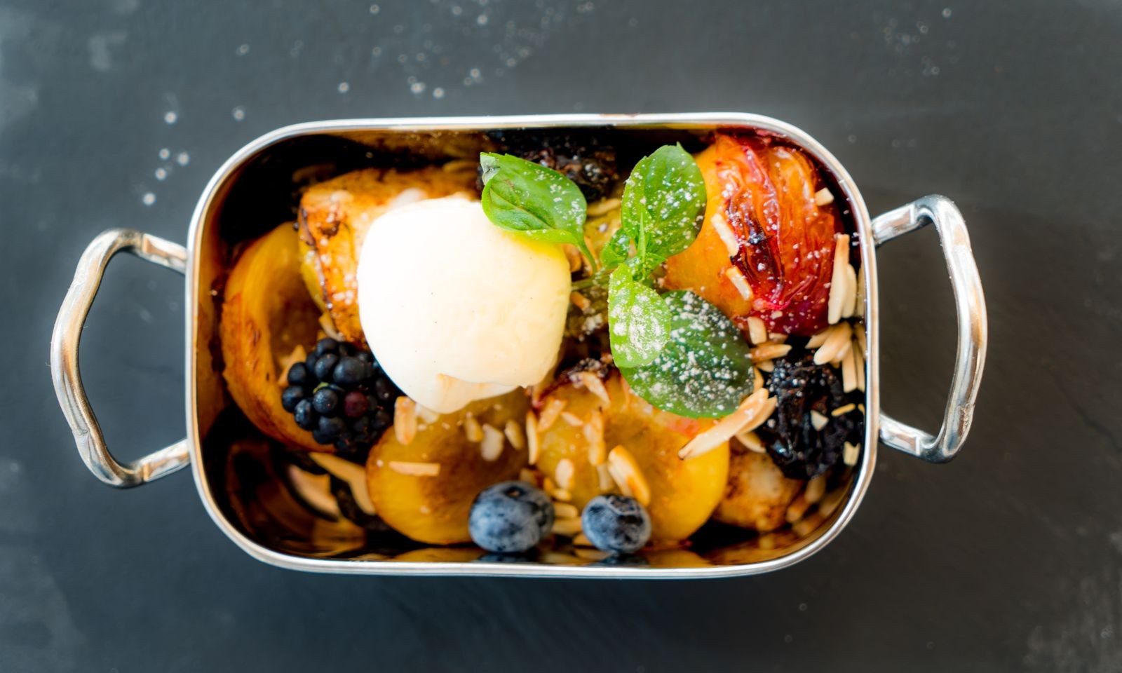 Warm fruit cobbler with a scoop of vanilla ice cream