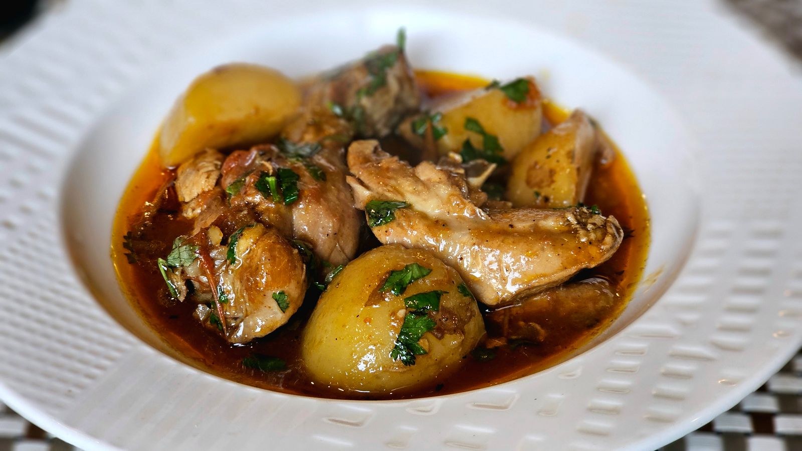 Braised chicken stew with potatoes and herbs
