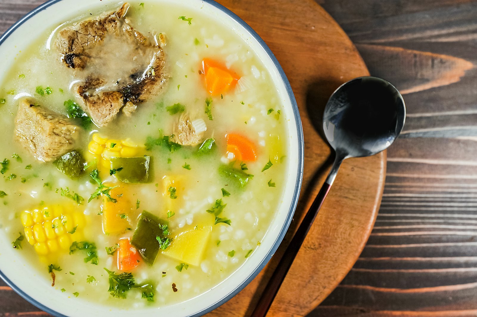 A bowl of creamy chicken soup with vegetables