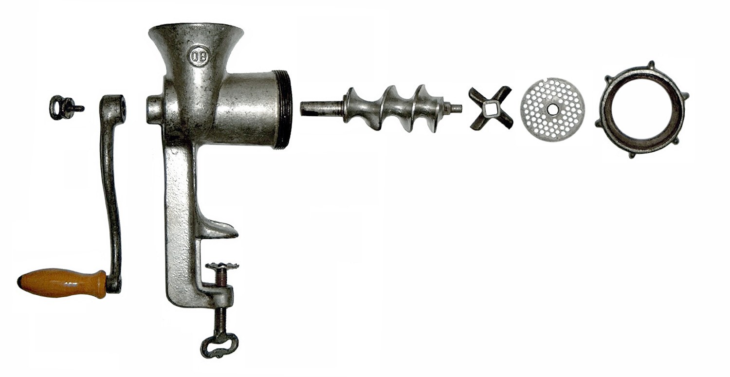 A hand-crank meat grinder taken apart to show its parts