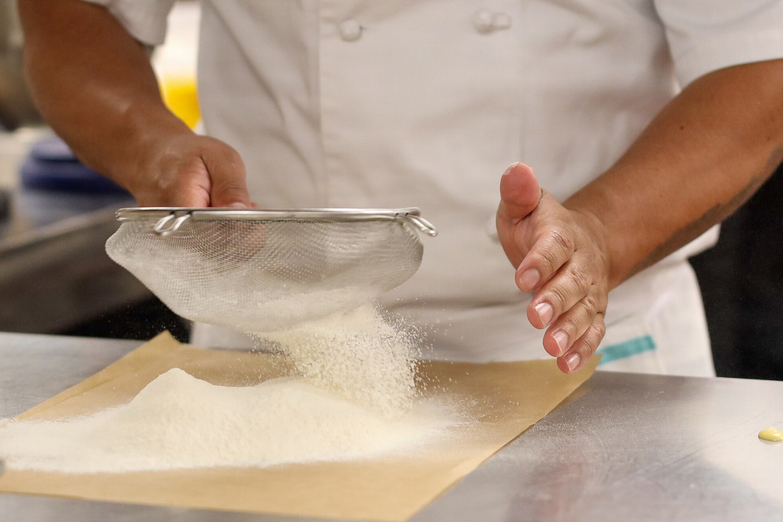 Vintage kitchen gadgets: sifting flour through a metal sifter