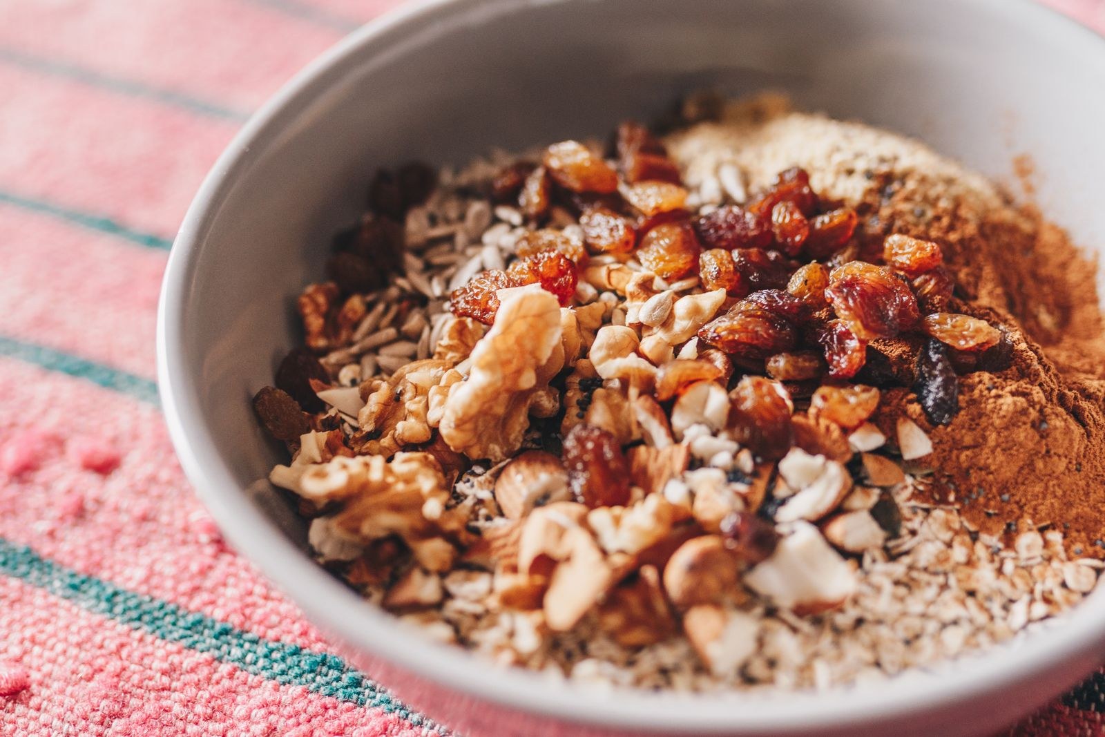 A bowl of oatmeal with nuts and fruit