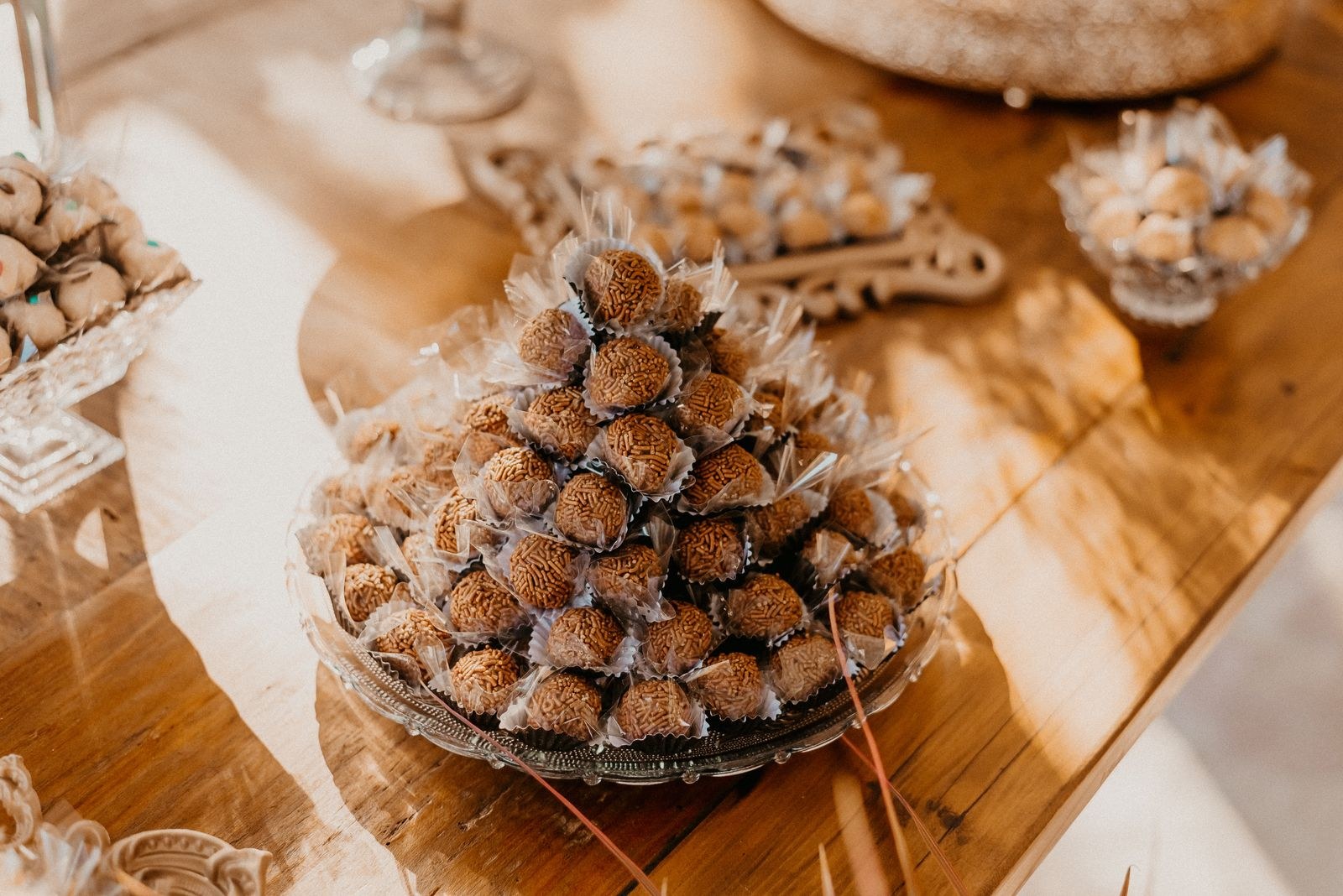 Chocolate-dipped truffle bites stacked on a board