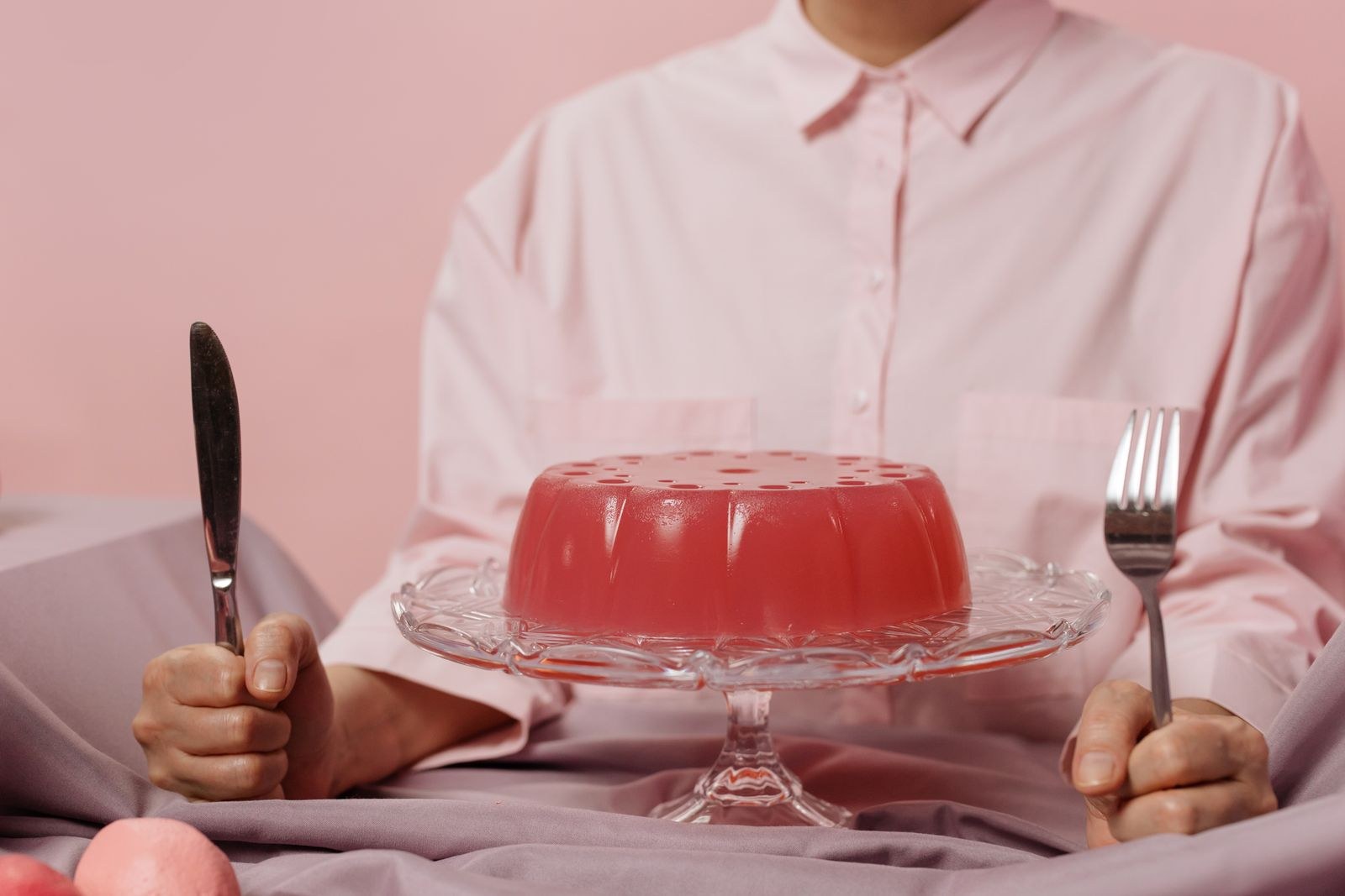 Red cranberry gelatin mold on a cake stand