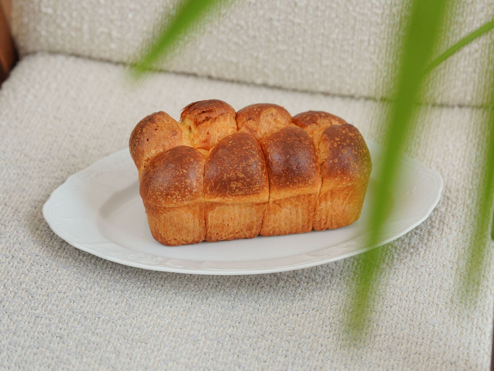 Soft golden brioche loaf on a plate