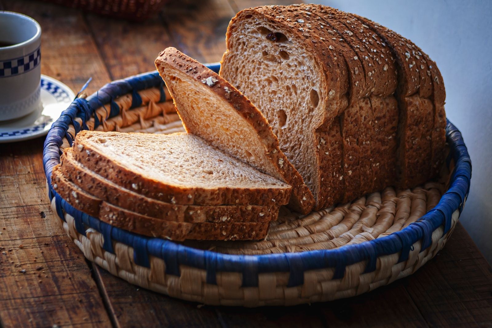 Sliced honey wheat loaf in a basket