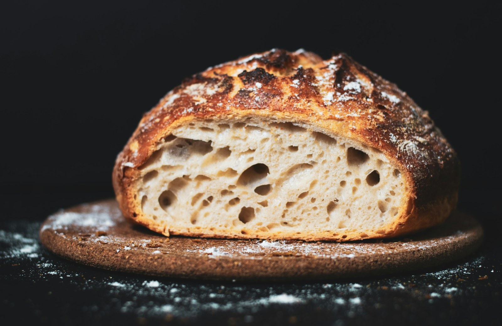 Crusty loaf of bread on a wooden board