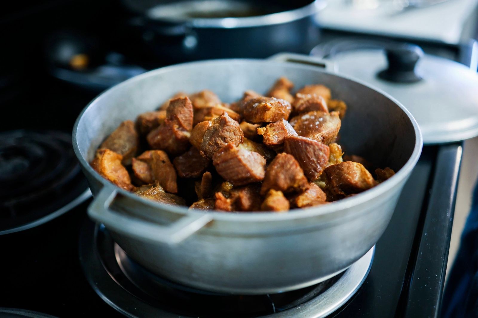 Seared chunks browning in a hot pot on the stove