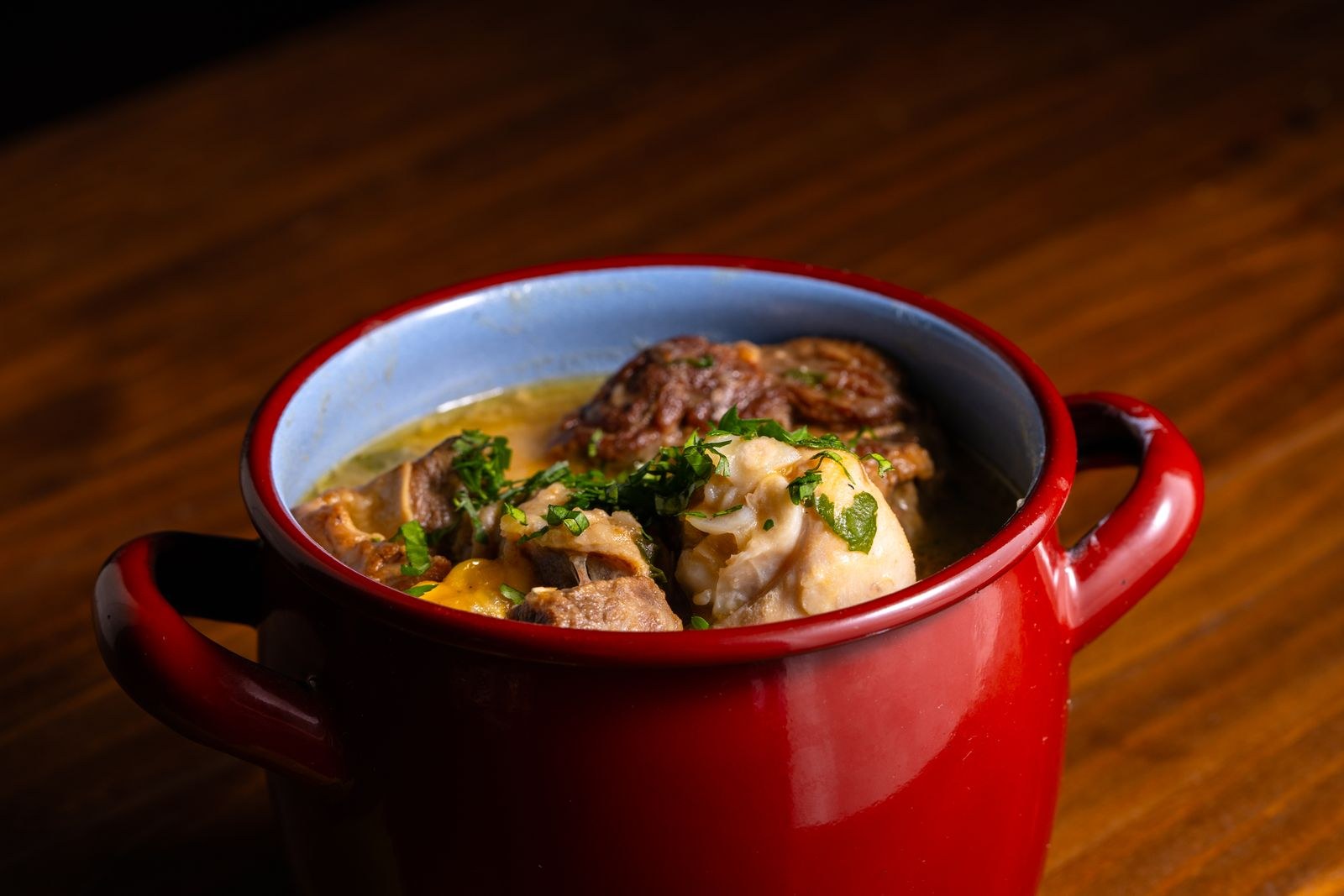 Beef stew in a red enameled Dutch oven