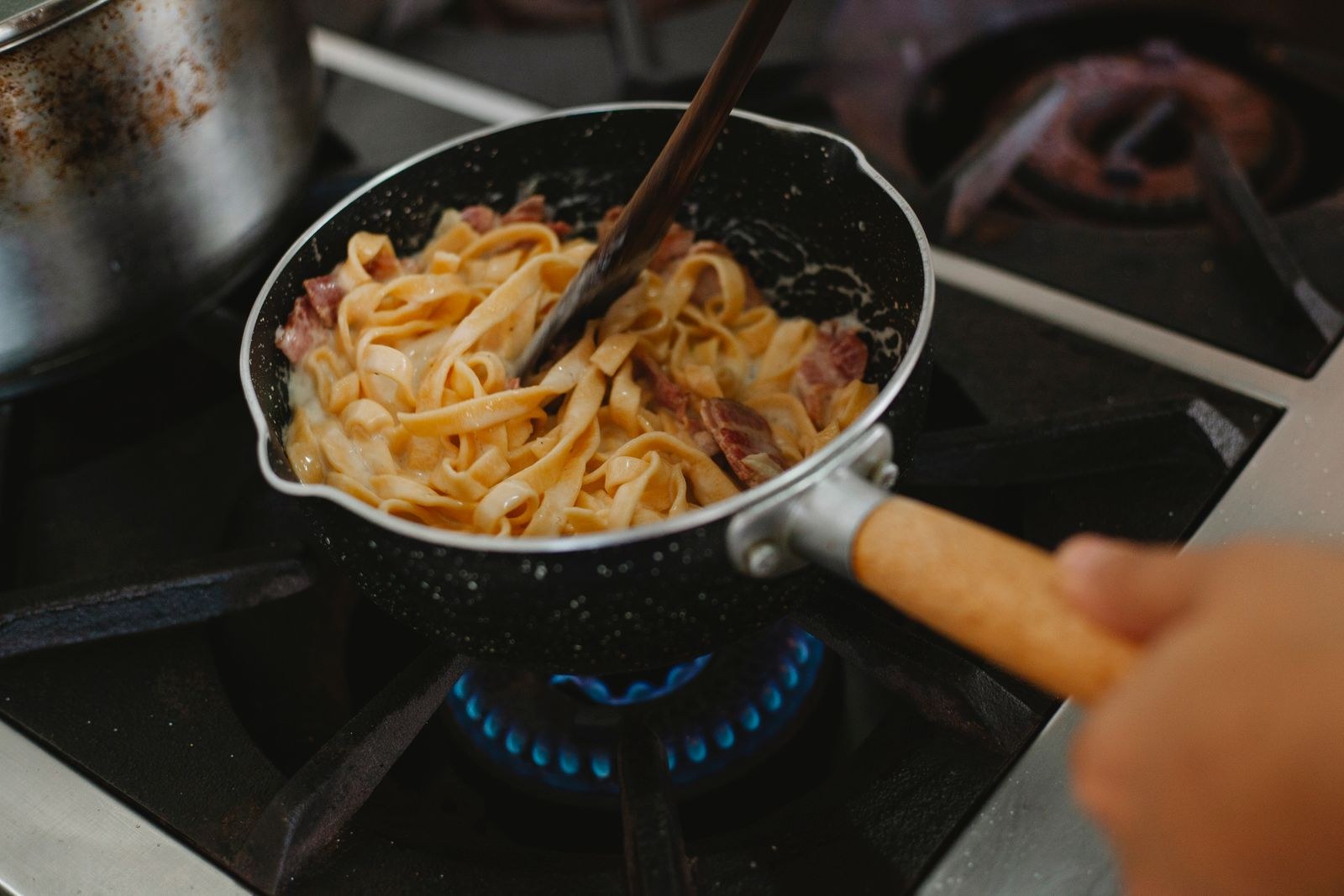 Pasta finishing in the sauce in a frying pan