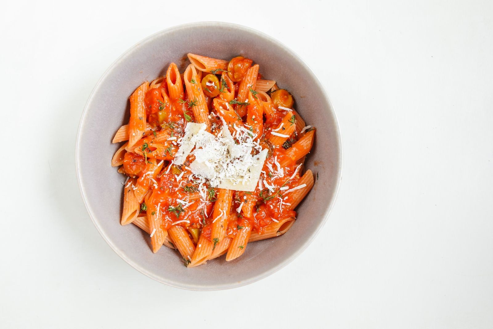 Bowl of penne in tomato sauce with Parmesan