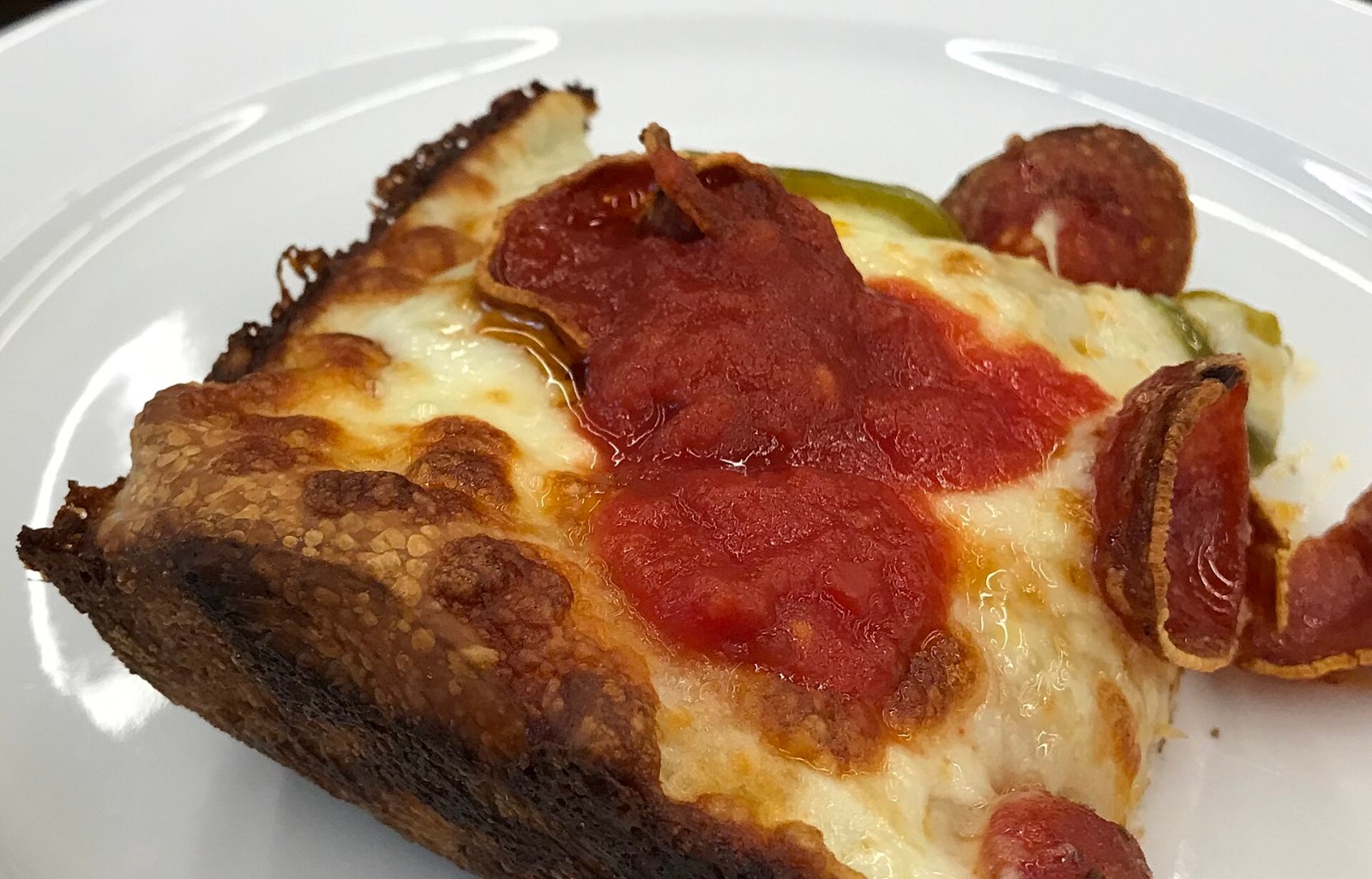 Detroit square slice with a crispy caramelized cheese edge