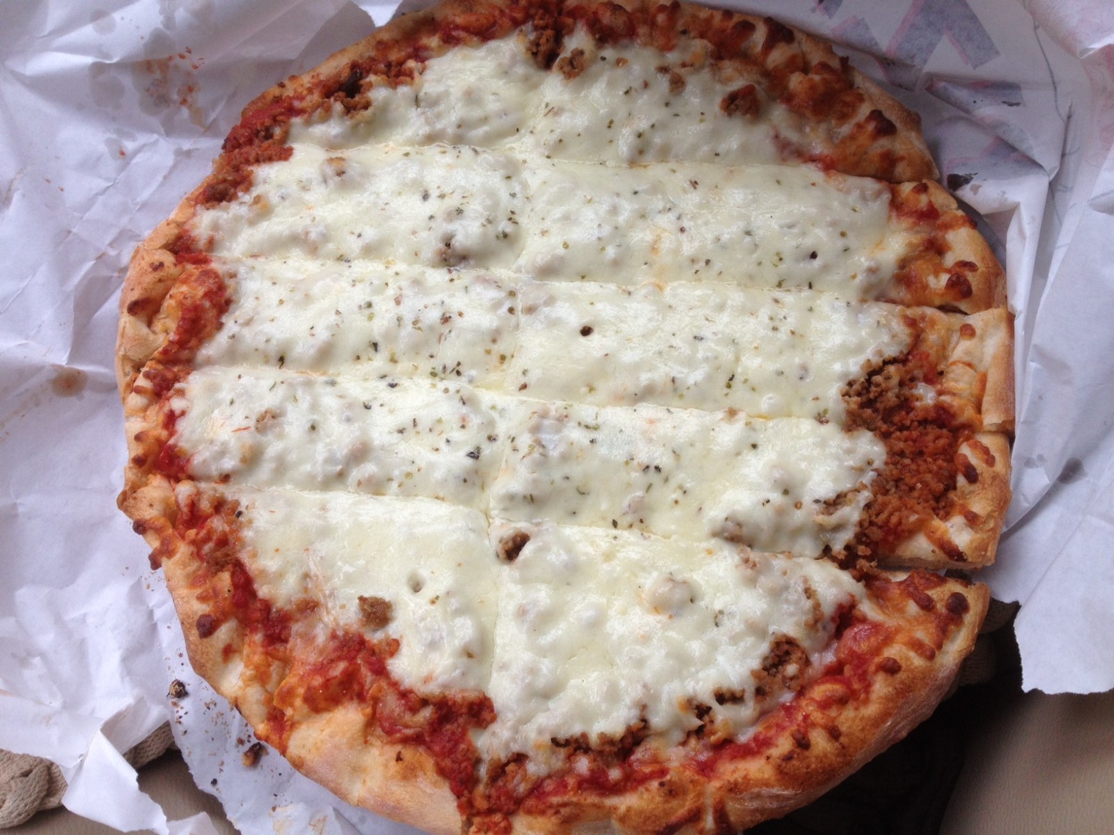Pizza styles: Quad Cities pizza with sausage under the cheese, cut in strips