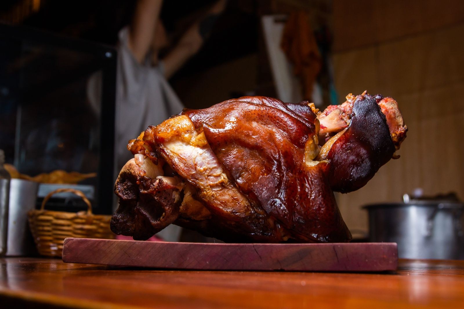 Roasted bone-in ham with a dark glaze on a board
